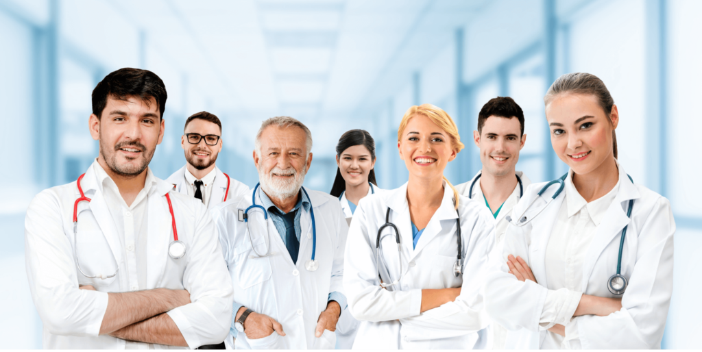 group of doctors in white coats smiling at the camera